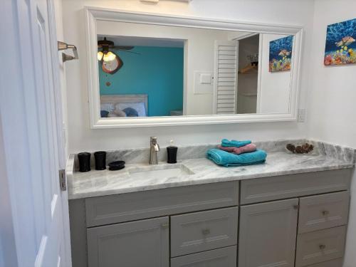 a bathroom with a sink and a mirror at Charming and Spacious Studio in Clearwater Beach