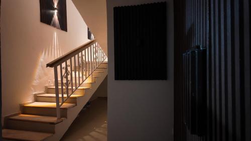 a staircase in a room with lights on the wall at Sultan Apartments Lagos in Lagos