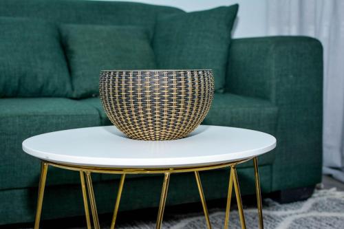a bowl sitting on a table in front of a green couch at Emerald Inn in Letlhakane