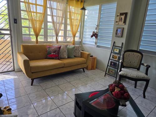 a living room with a couch and a chair at Casa Campo y mis Memorias-2ND LEVEL-with pool in Hormigueros