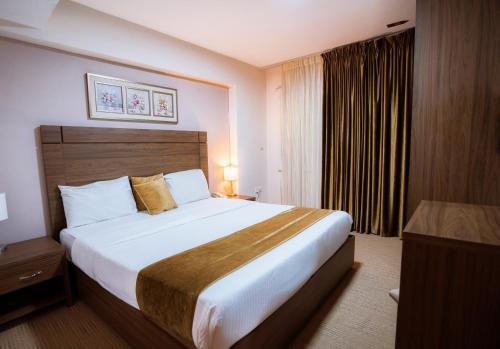 a bedroom with a large bed in a hotel room at Rawa Luxury Hotel Suites in Amman