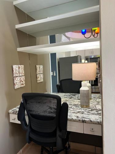 a desk with a chair in front of a mirror at OCEAN VIEW GETAWAY! Penthouse Studio in Punta de Mita! in Punta Mita