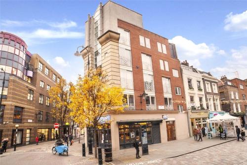 a building on a city street with people walking around at Seven Dials, Covent Garden - a one-minute walk to Soho - see full details in my profile below in London