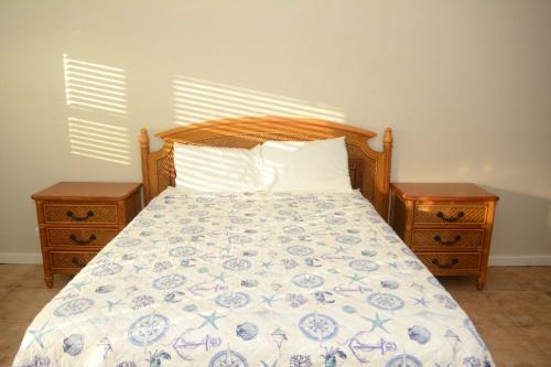 a bedroom with a bed with two nightstands and a bed sidx sidx sidx at Exuma Beach Point in Rolleville