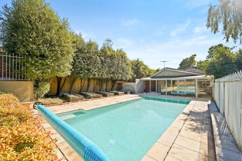 a swimming pool in the backyard of a house at Elegant Luxury - Family Entertainer in Ringwood in Ringwood