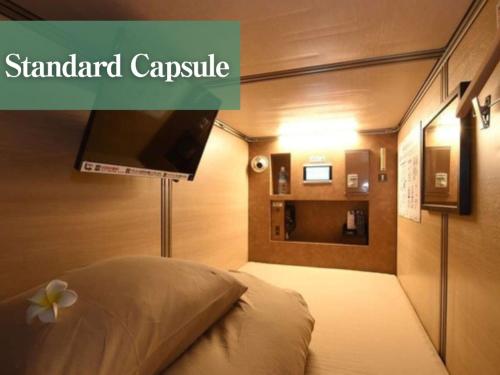 a hotel room with a bed with a flat screen tv at Anshin Oyado woman Tokyo Ginza Shiodome in Tokyo