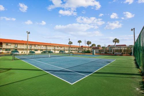 a tennis court in front of a building at Charming Beach Condo in St Augustine in Saint Augustine