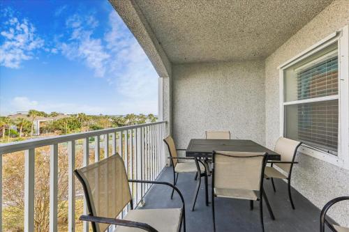 a balcony with a table and chairs and a window at Two Bedroom St Augustine Retreat in Saint Augustine