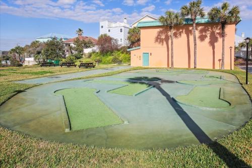 an empty golf course in a park with palm trees at Oceanview Retreat in St Augustine in Saint Augustine