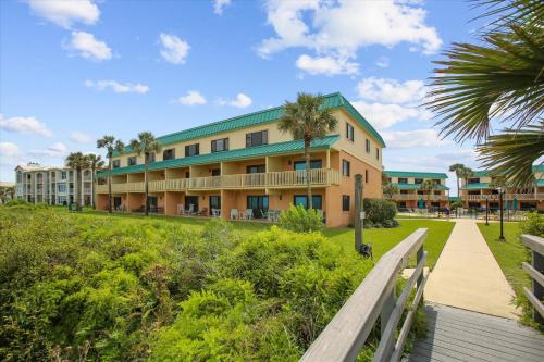 a building on the beach with a boardwalk at Oceanview Retreat in St Augustine in Saint Augustine
