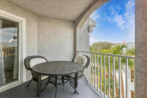 a porch with a table and chairs on a balcony at Tranquil Coastal Retreat in St Augustine in Saint Augustine