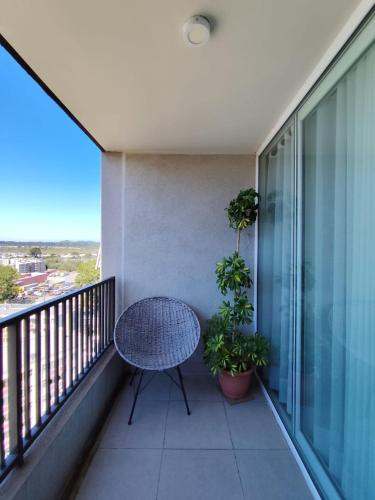 a balcony with a table and potted plants at Departamento Salida Norte Temuco in Temuco