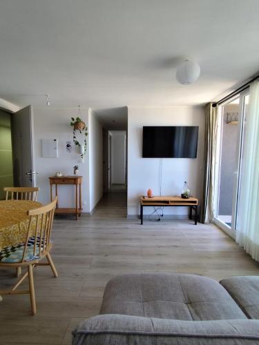 a living room with a couch and a table at Departamento Salida Norte Temuco in Temuco