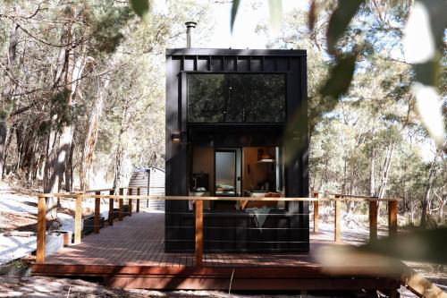 a black tiny house in the woods at SHAK Halls Gap - Off Grid Tiny Home in Halls Gap