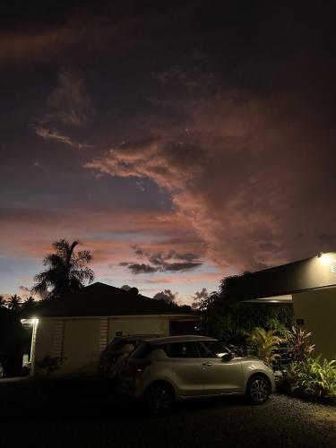 a car parked in front of a house at night at Ononui Airport Studio in Faaa