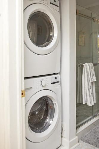 a washer and dryer in a corner of a room at The Higashi King bed mountain home in New Paltz in New Paltz