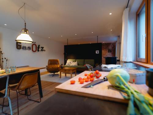 ベルヒテスガーデンにあるFerienapartment Gasötz Berchtesgadenのリビングルーム(トマトをトッピングボードに乗せたテーブル付)