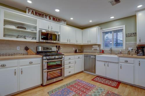 a large kitchen with white cabinets and a rug at Northern Lights in White Salmon