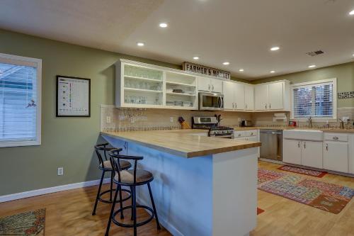 a kitchen with white cabinets and bar stools at Northern Lights in White Salmon