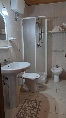 a bathroom with a sink and a toilet and a shower at Casa Marietta in Villa D'agri