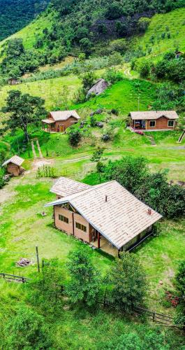 an aerial view of a house on a hill at Chalé Araucária- Vale das Pedras MG in Sapucaí-Mirim