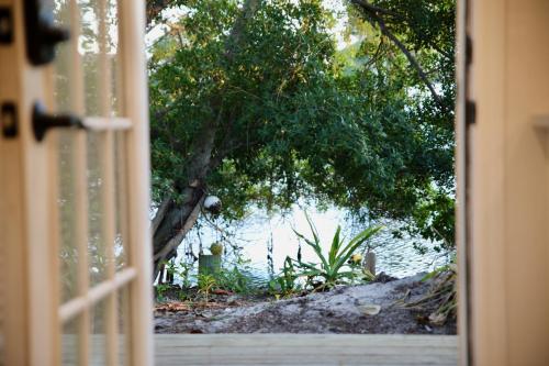 a door open to a view of a body of water at Bamboo Bungalow - Waterfront Studio Near Beach in Cocoa Beach