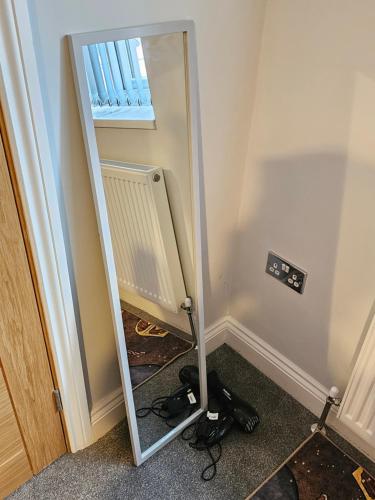 a mirror in the corner of a room at Potters Hideout- 2 Bedroom 2 Bathroom Apartment in Watford
