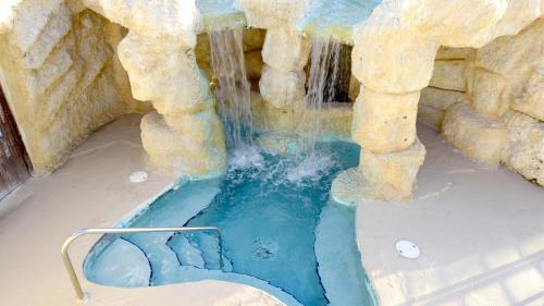 a fake waterfall in a pool in a water park at 409 Mariners Club in Key Largo