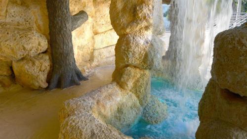 a waterfall in a zoo with rocks and water at 409 Mariners Club in Key Largo
