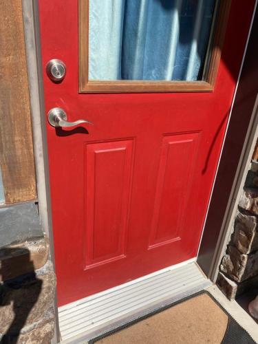 a red door with a window on it at Pika's Place Bed and Breakfast in Canmore