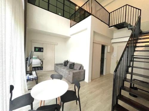 a living room with a table and a couch at TREX Buriram Boutique Hotel in Buriram