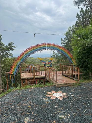 a playground with a rainbow arch in a park at hostal Sueño Paraiso- Observatorio astronómico in Popayan