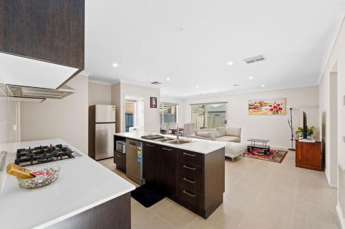 a kitchen and living room with a stove top oven at Hartleigh Estate - Sophisticated Family Living in Clyde