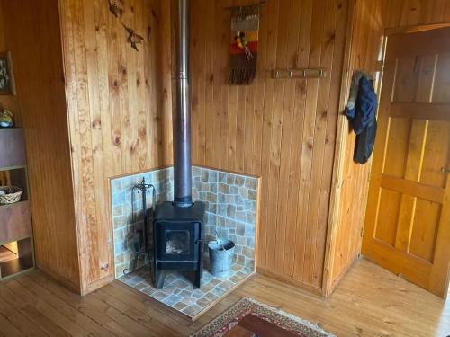a woodburning stove in a room in a house at Casa vista hermosa Quellon in Quellón