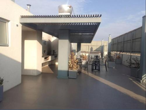 a balcony with tables and chairs on a building at 17 Apartamento en Santiago en frente a Metro - Estadio - Hipodromo de Chile in Santiago