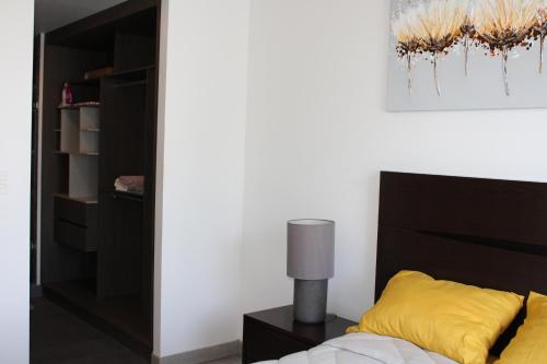 a bedroom with a bed and a black headboard at Loft Cerca Plaza Mayor in Miravalle