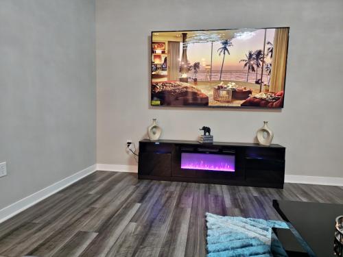 a living room with a fireplace and a tv on the wall at Cozy 5 bedroom and 4 bathroom in Brownsburg