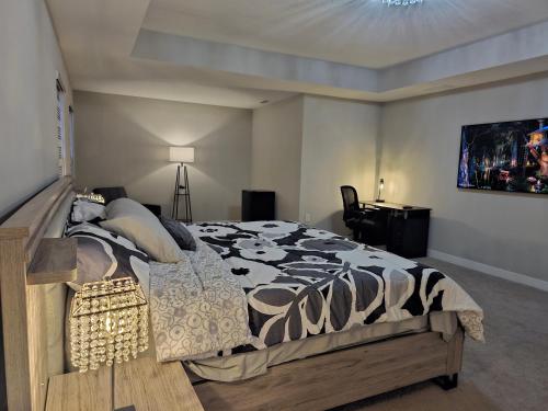 a bedroom with a bed with a black and white comforter at Cozy 5 bedroom and 4 bathroom in Brownsburg
