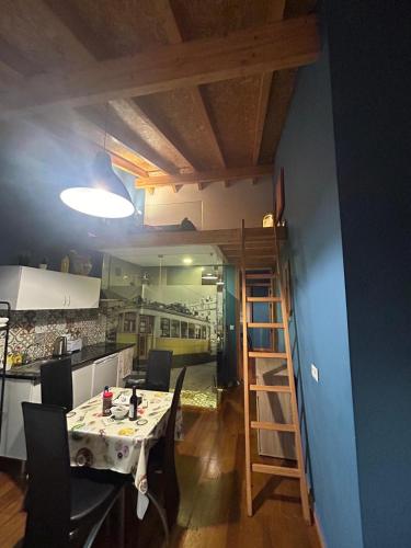 a room with a table and chairs and a kitchen at Sao Jorge Apartments & Suites in Lisbon