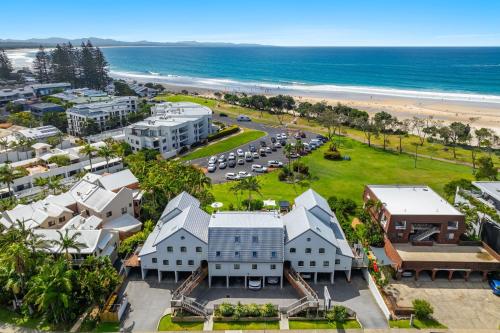 an aerial view of the beach and buildings at Byron Bay Beachfront Holiday Apartments in Byron Bay