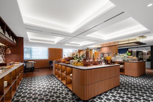 a large kitchen with a counter with food at Intercity Guangzhou Huadu in Huadu