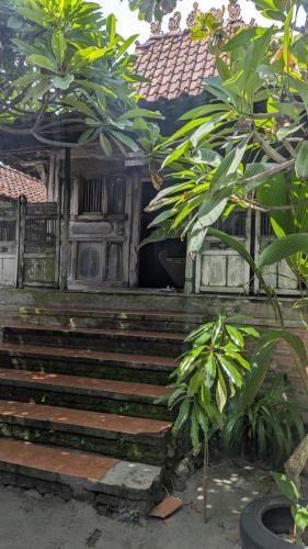 a building with stairs and plants in front of it at Cafe de Paris Homestay in Girijati