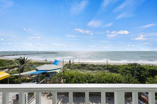 a view of the beach from a balcony at Oceanfront Inn Room #23 - Ocean View Balcony King Bed in Fort Pierce