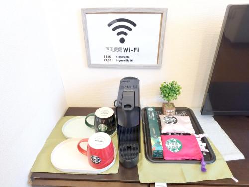 a table with a tray with a phone on it at ビーチまで徒歩5分 BBQ無料 7名迄OK 戸建て貸切宿 Bignet villa in Miyamae