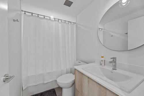 a bathroom with a sink and a toilet and a mirror at Beach Lake Resort in Kelowna