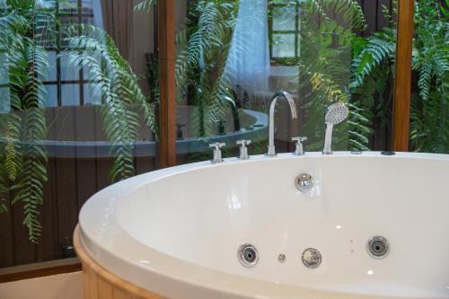 a white sink with a faucet in a bathroom at Thongkwao house in Chiang Mai