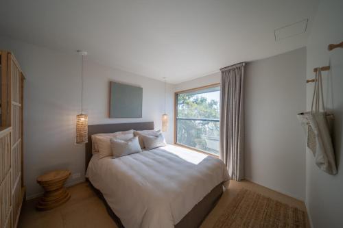a bedroom with a large bed and a window at Cantilever House - Town of 1770 in Seventeen Seventy