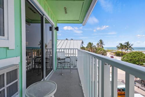 a balcony with a view of the beach at Oceanfront Inn Room #21- Ocean View Balcony King Bed in Fort Pierce