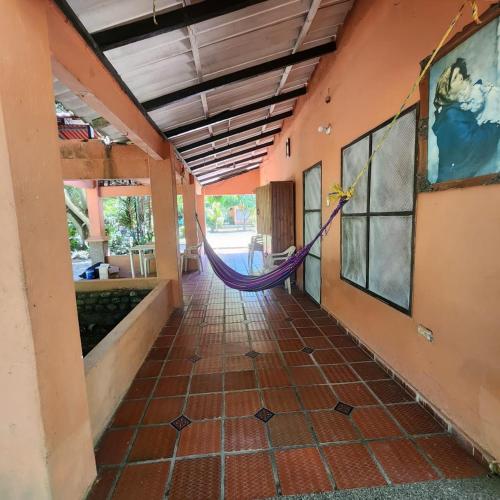 a hallway with a hammock in a building at CABAñA EDEN in Santa Marta