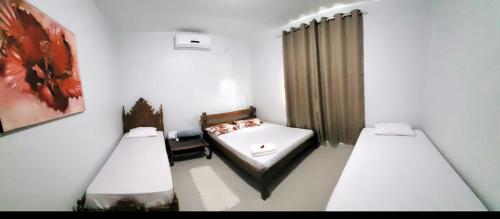 En eller flere senge i et værelse på Rancho Tertúlia Lago Corumbá IV